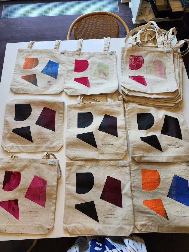 colourful tote bags laid on table